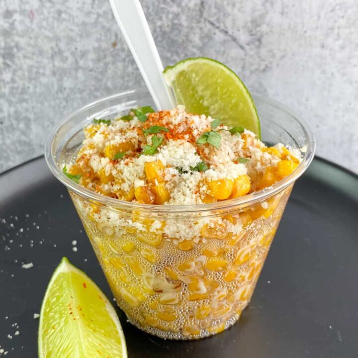 Elote in a cup made with canned corn, Mexican spices, cotija cheese and lime.