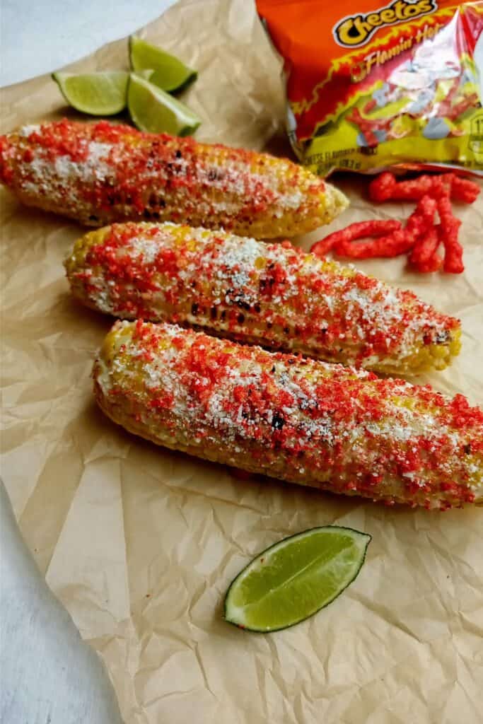 Mexican style corn on the cob with crushed hot Cheetos.