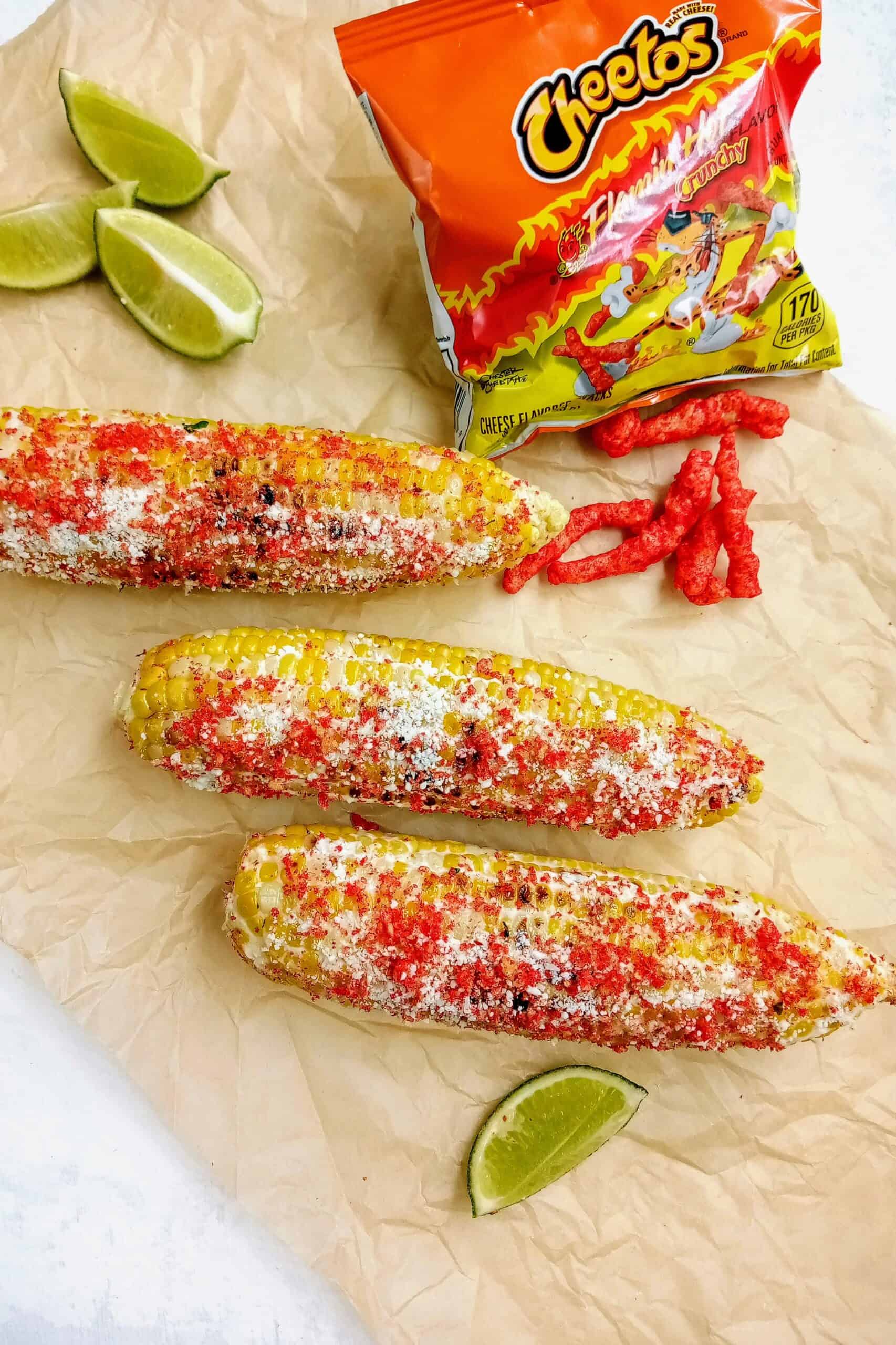 Elote with hot Cheetos topped with Cotija cheese and chili lime salt