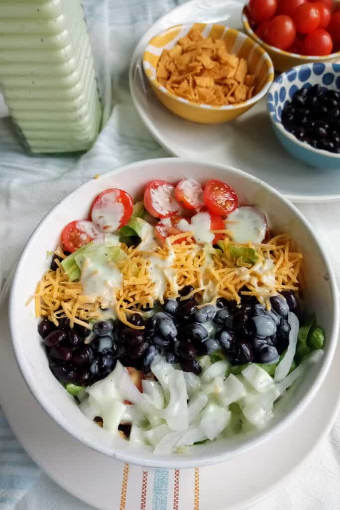 Taco salad with beans and creamy dressing.