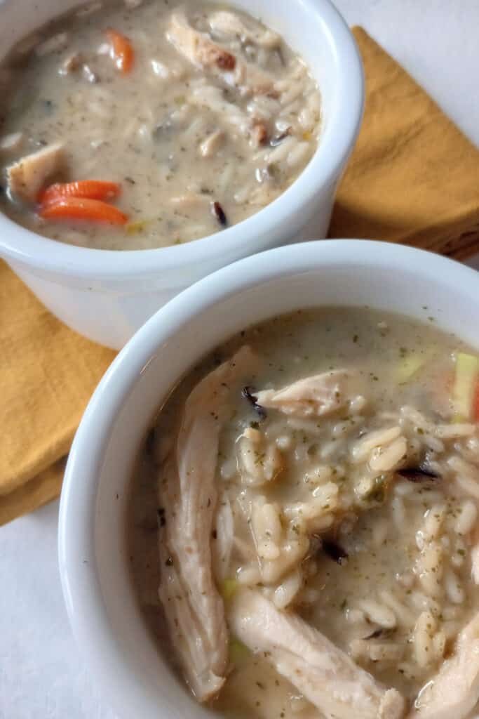 Cream of turkey soup with wild rice, chopped leek, sliced carrots, and diced mushrooms.