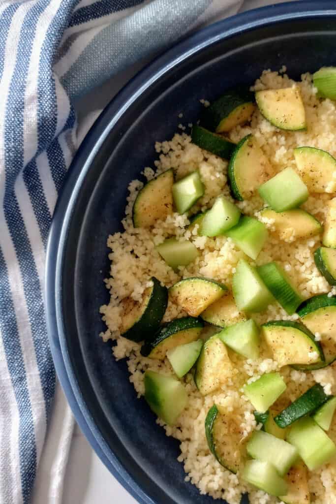 Couscous with pan-seared zucchini, sliced cucumber, and seasonings.