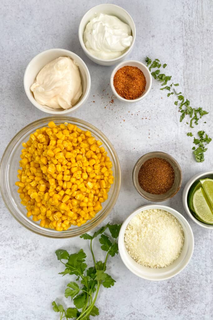 Ingredients to make elote Mexican street corn in cups using canned corn.
