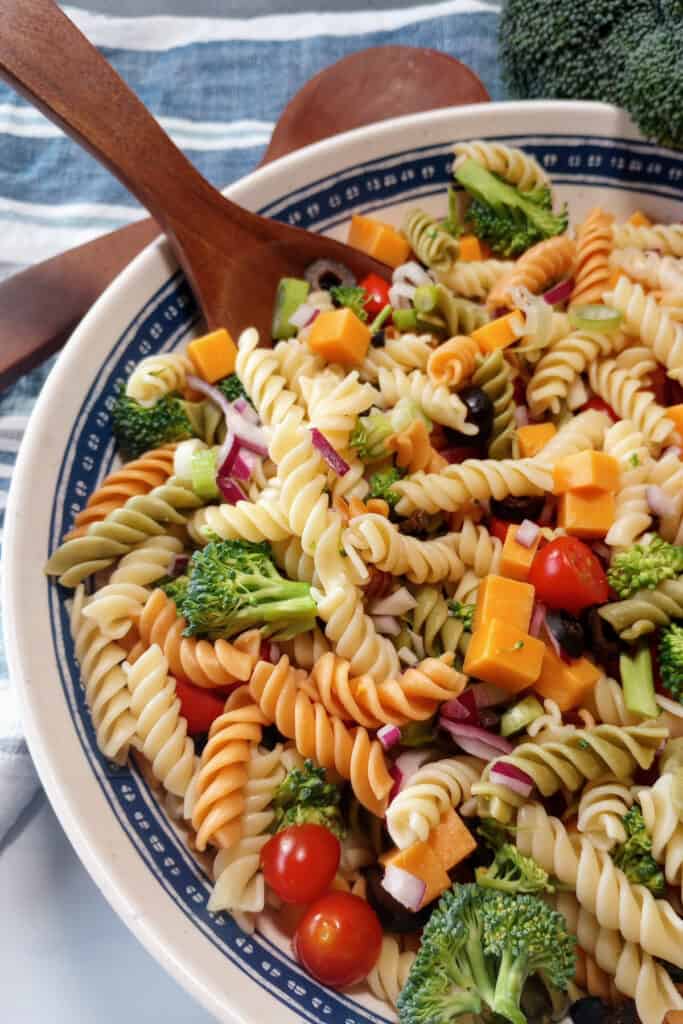Pasta salad with wooden spoons.