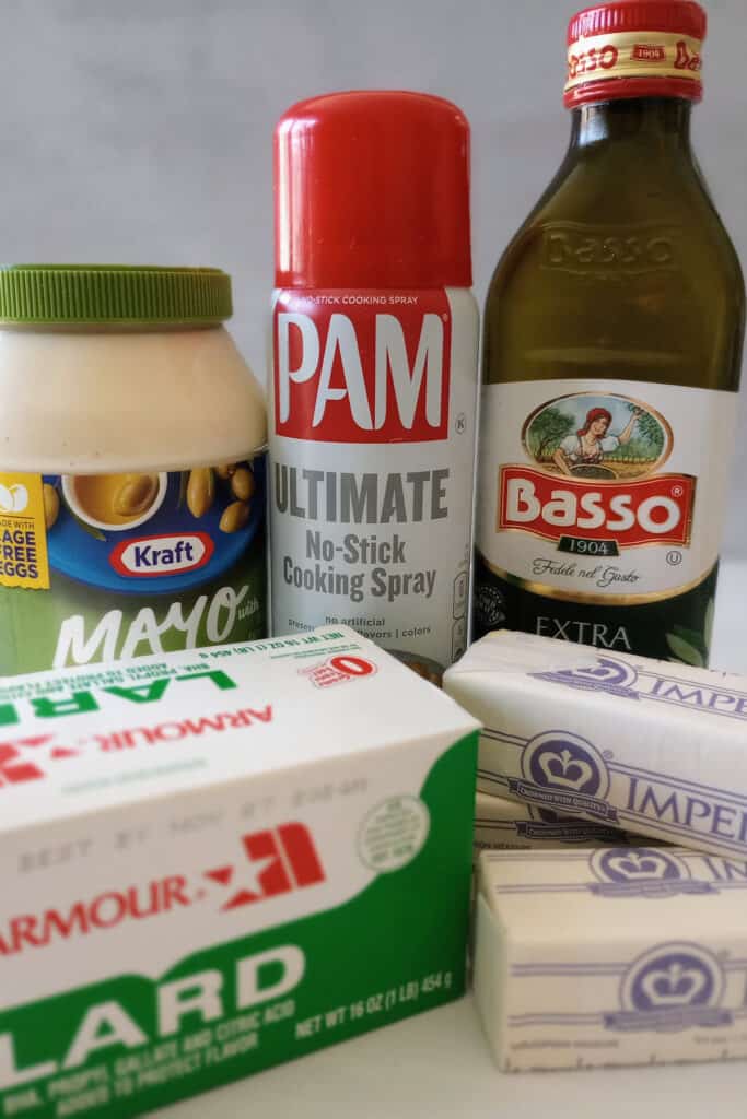 Mayo, lard, Pam cooking spray, olive oil, and margarine are all tasty butter replacements that can be used to make a grilled cheese sandwich. 