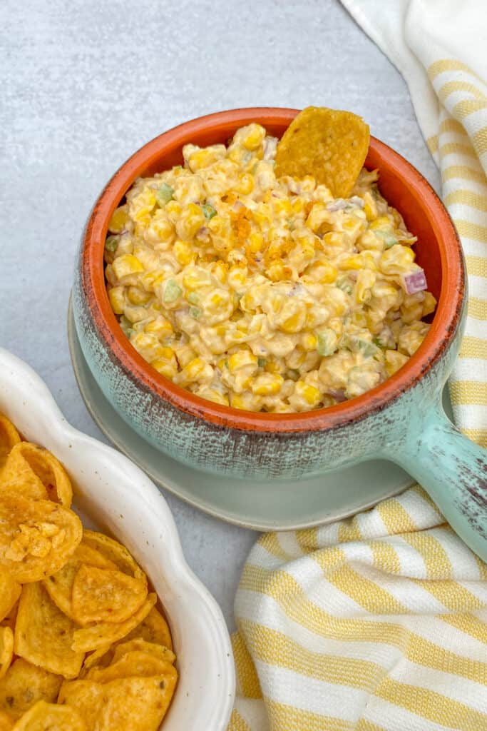 Bowl of Frito Corn Dip with a Fritos Scoop chip in it.