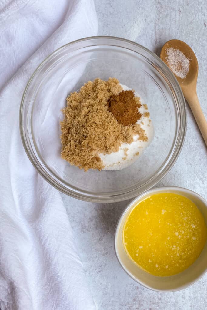 Sugar, cinnamon and melted butter for making peach dumpling topping.