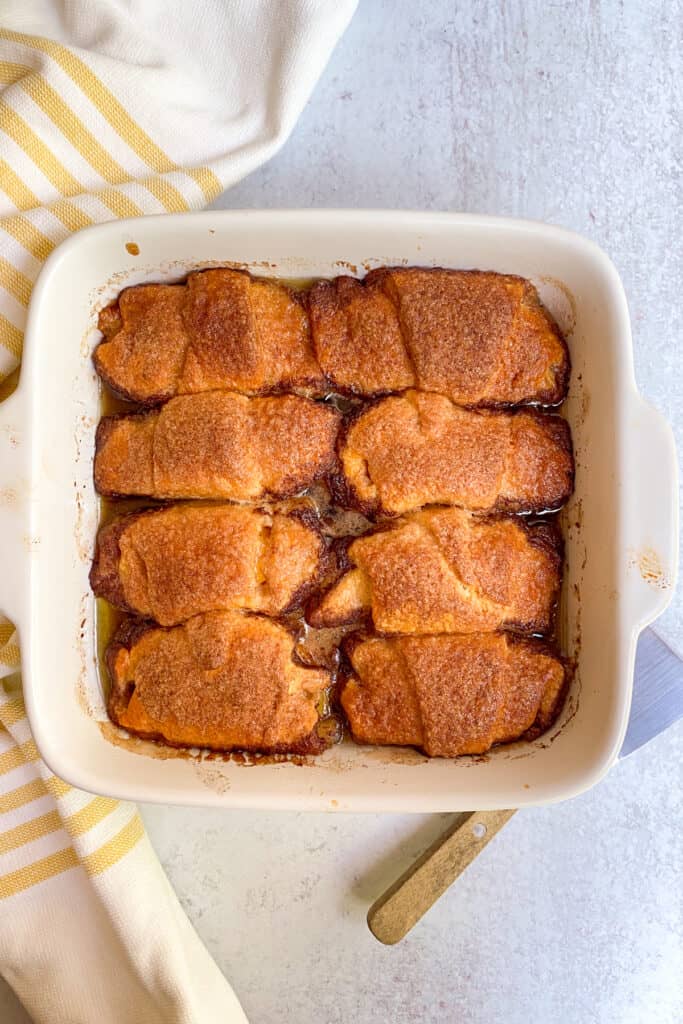 Eight baked peach dumplings.