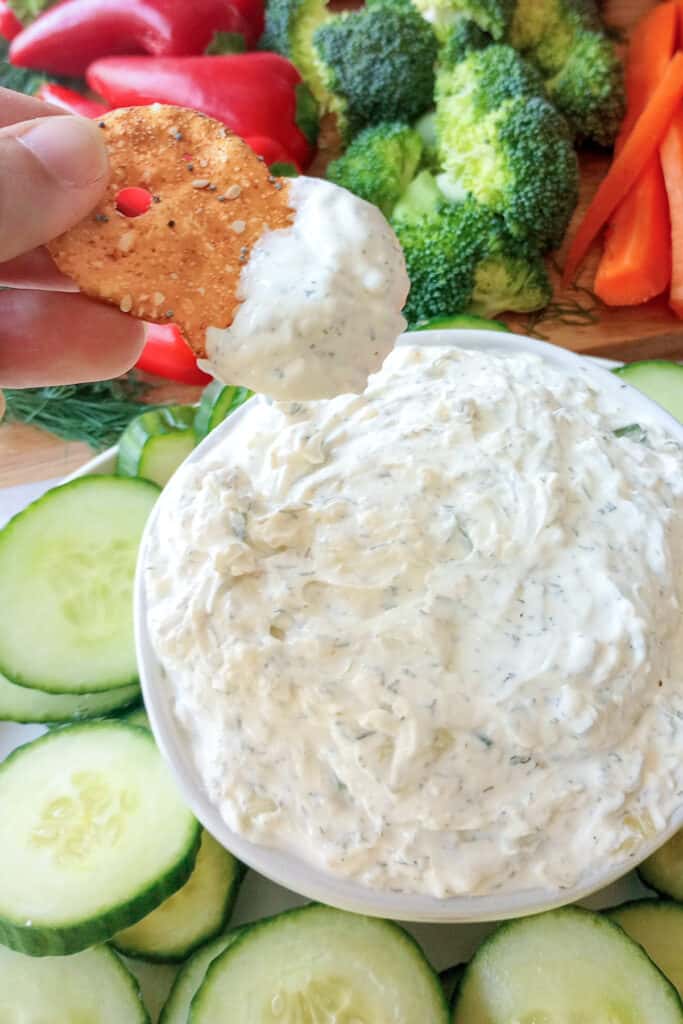 Cucumber dill dip served with gluten free everything seasoned bagel chips. 