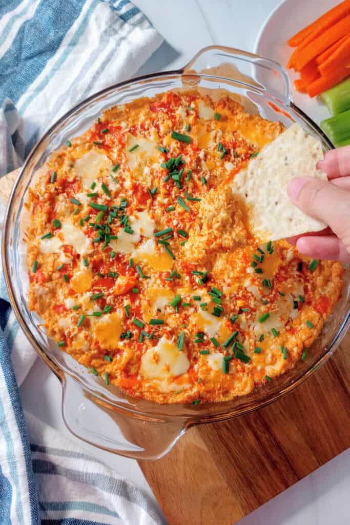 Tortilla chip is scooping up an ooey, gooey, bite of Franks Red Hot buffalo chicken dip.
