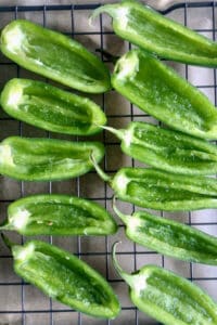 Cut and hallowed out jalapenos ready to be stuffed with cream cheese mixture.