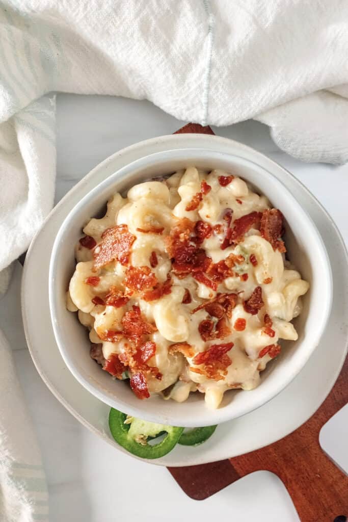Creamy jalapeno bacon mac and cheese in a white bowl.