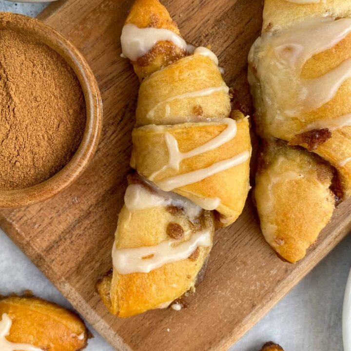 Cinnamon Sugar Crescent Rolls for dessert drizzled with sweet vanilla glaze and buttery cinnamon oozing out of the roll.
