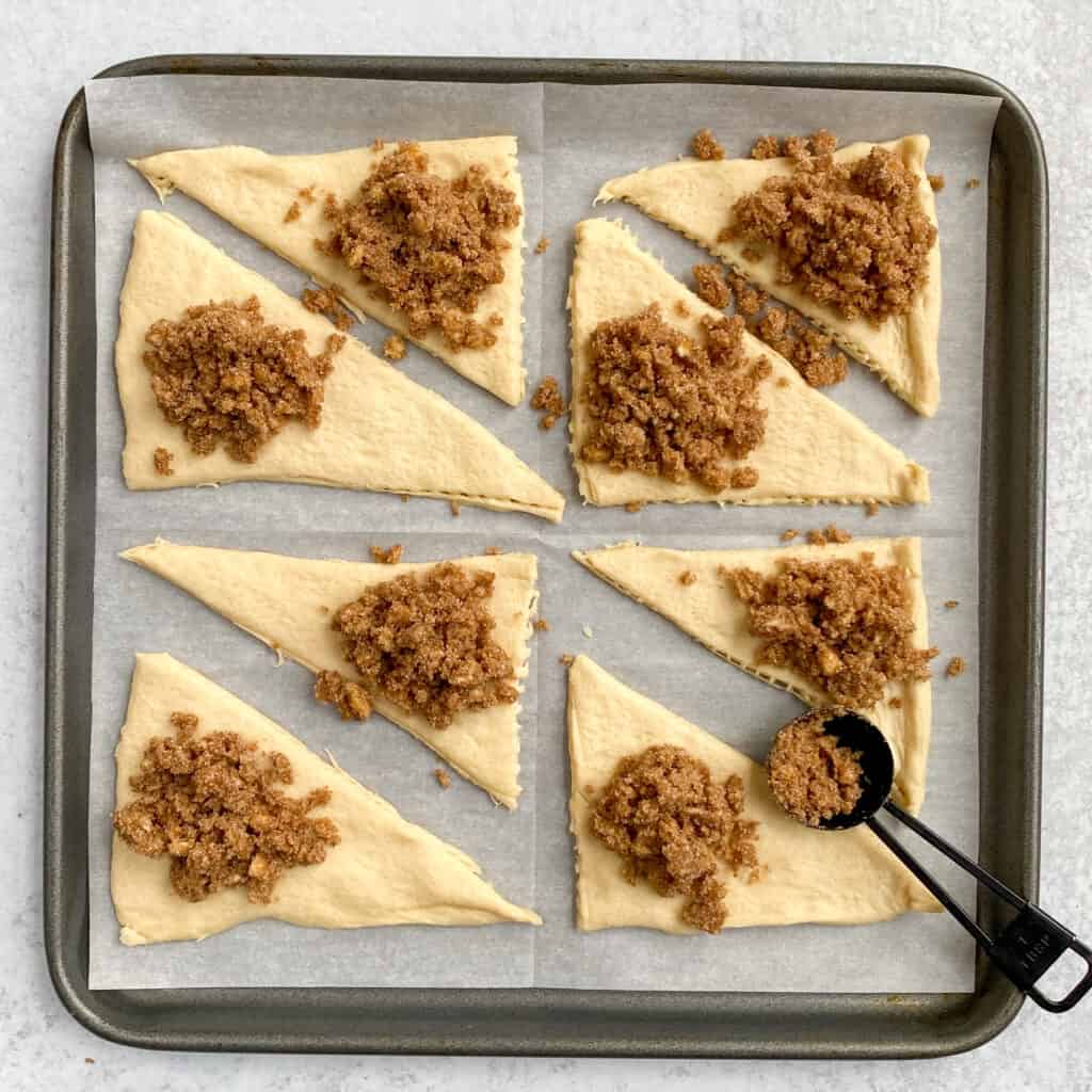 Scoop of cinnamon sugar filling on each crescent.