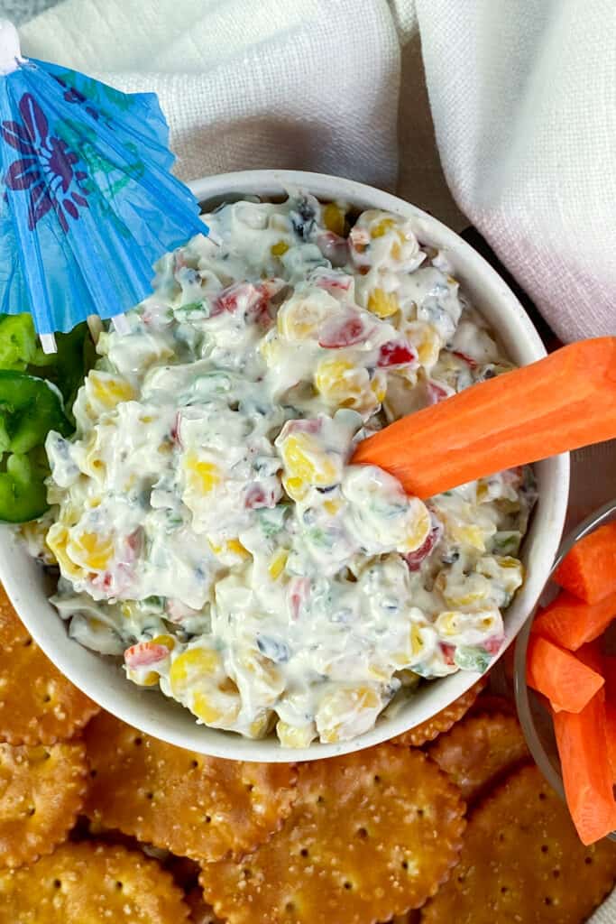 Bowl of Skinny Poolside Dip with a carrot stick dipped in it.