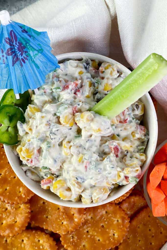 Bowl of Skinny Poolside Dip with a celery stick dipped in it.