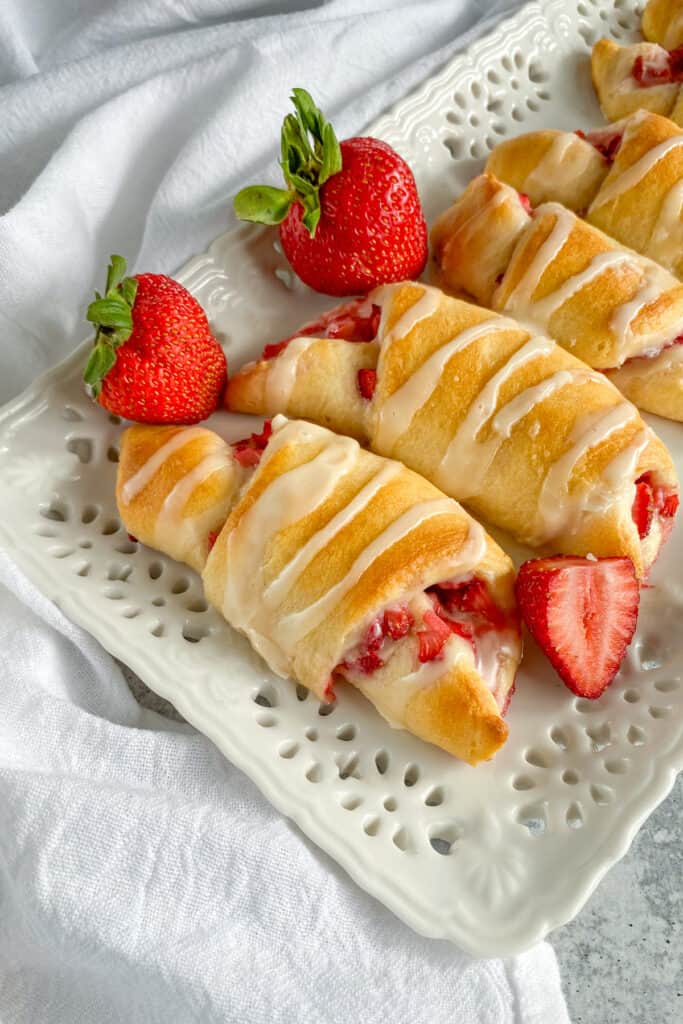 Strawberry Cream Cheese Crescent Rolls with sweet vanilla glaze drizzled on top.