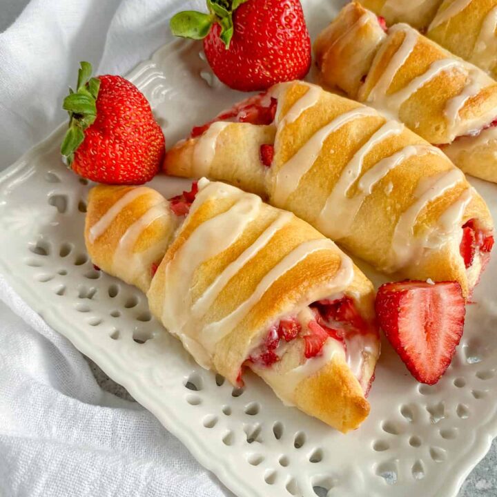 Strawberry Cream Cheese Crescent Rolls with sweet vanilla glaze drizzled on top.