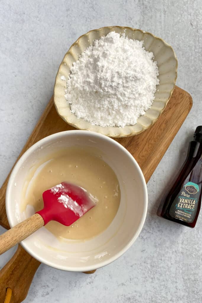 Mixing bowl with vanilla glaze topping all stirred together.