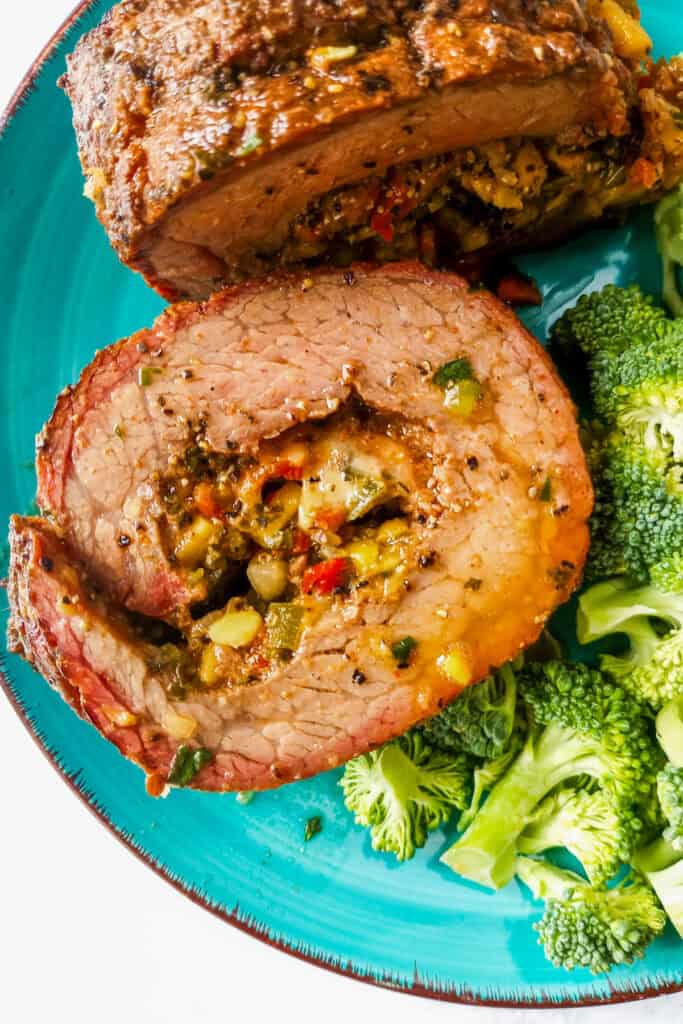 Grilled flank steak roll up stuffed with cheese and salsa.