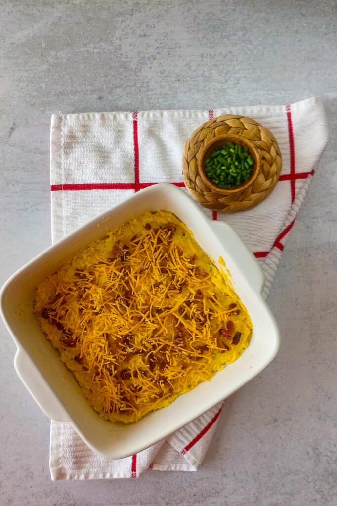 Baking dish topped with more shredded cheddar cheese. 