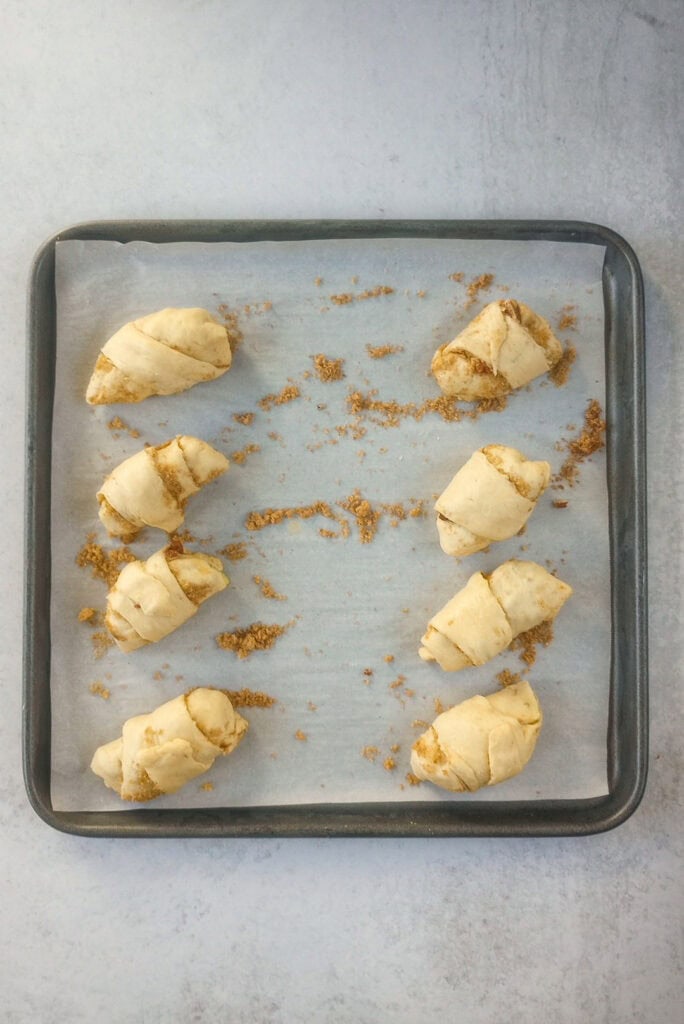 Overhead picture of apple pie dumplings ready to be baked in the oven. 