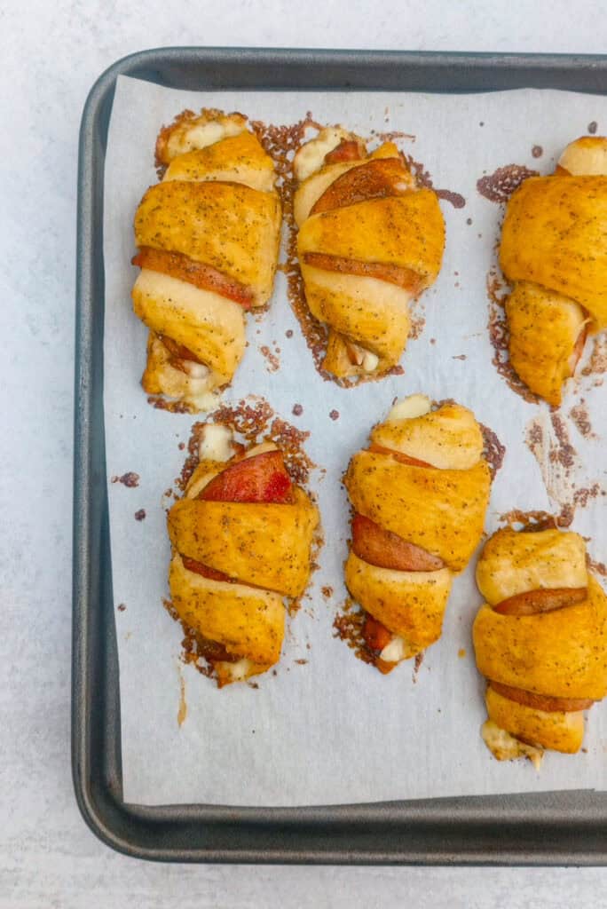 Overhead picture of ham and Swiss crescent rolls- ups fresh out of the oven. 