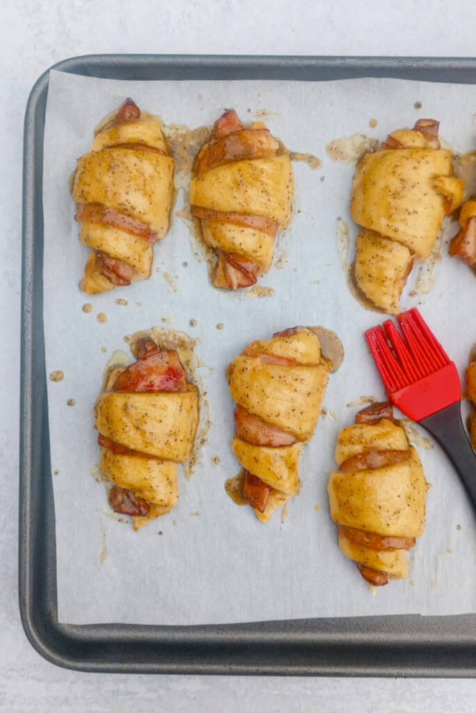 Overhead picture of ham and Swiss crescent rolls brushed with honey Dijon glaze. 