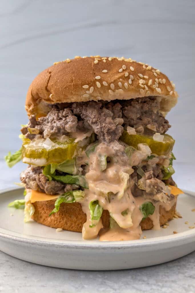 A double-high big mac sloppy joe sandwich loaded with ground beef, pickles and special sauce.