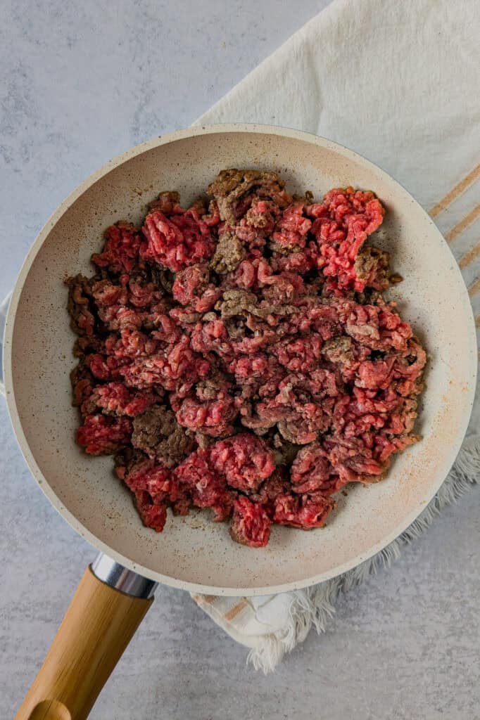 Over head picture of ground meat in a skillet. 