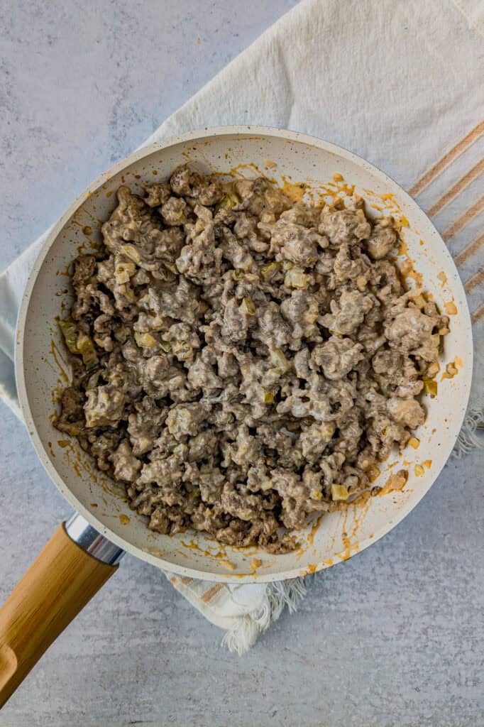 Overhead picture of ground meat slathered in secret sauce. 