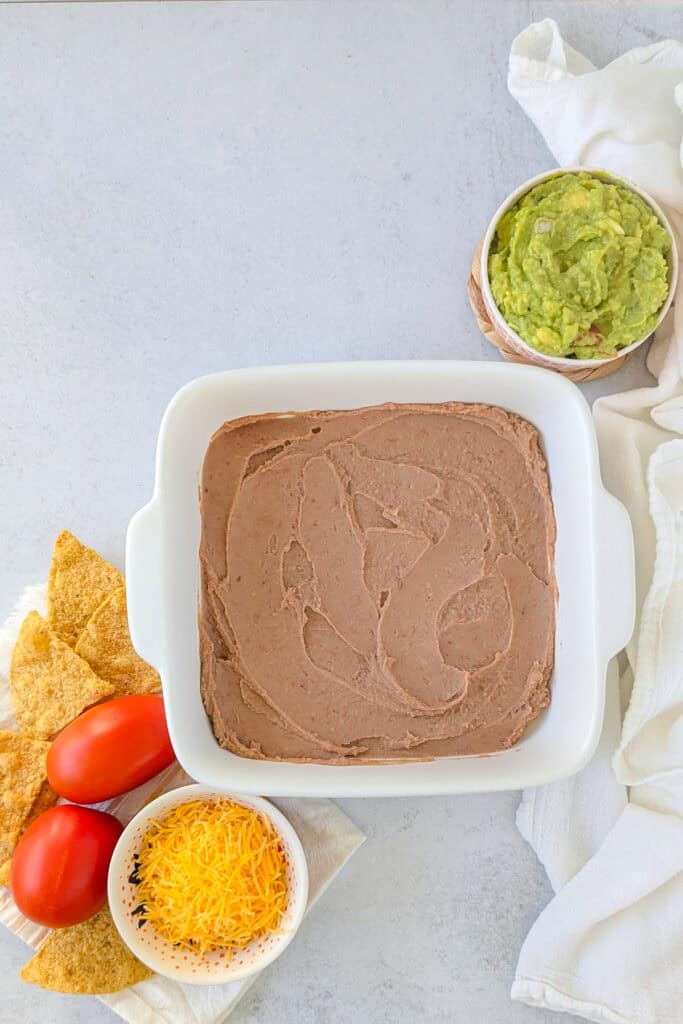 Overhead picture of refried beans in a baking dish. 