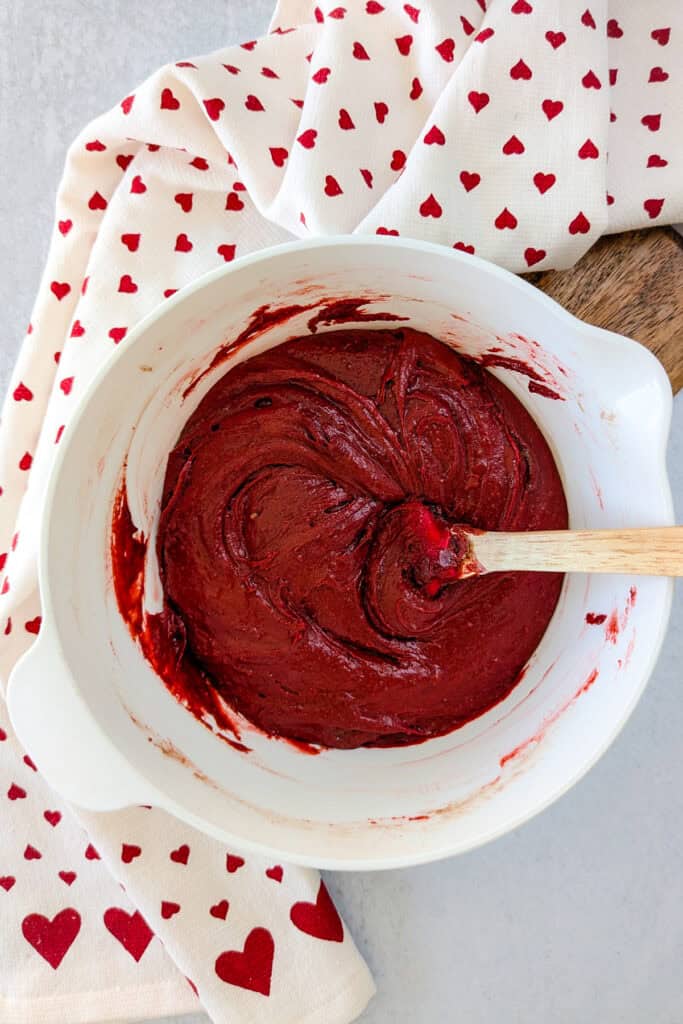 Overhead picture of Stirred brownie batter. Reserve a half a cup and spoon the rest of the brownie batter into the bottom of a 8x8 inch baking dish. 