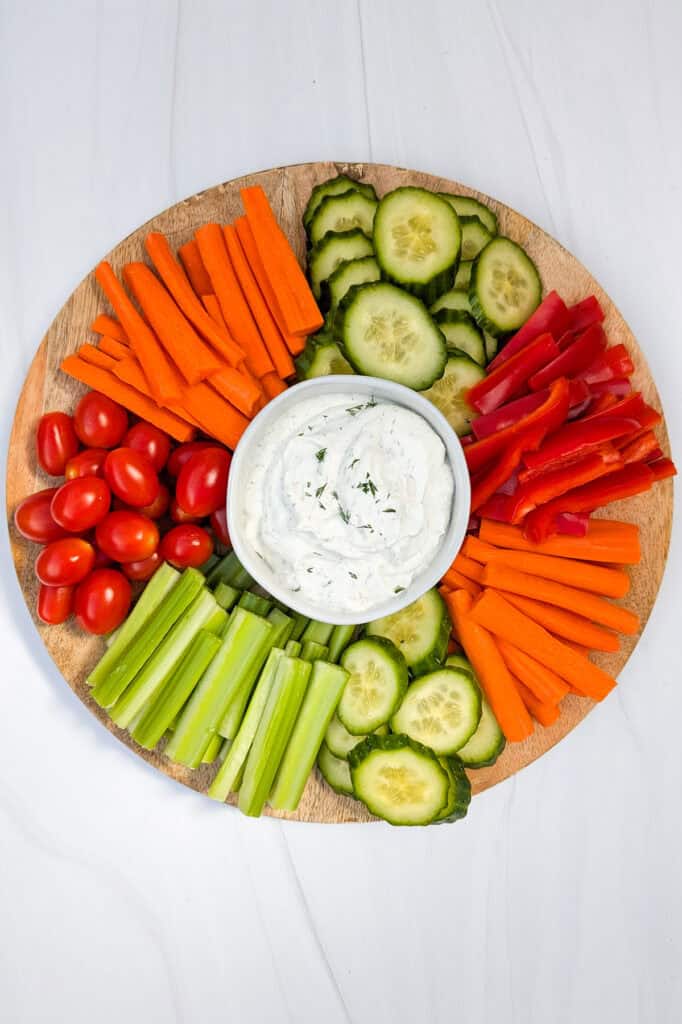 Overhead picture of healthy Greek yogurt veggie dip with fresh vegetables. 