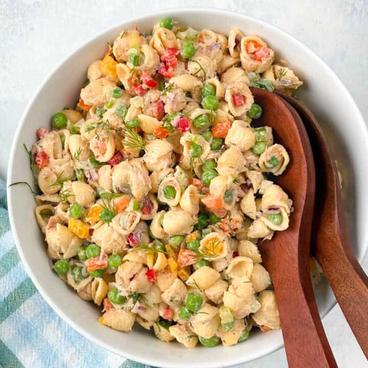 Overhead picture of tuna pasta salad up close with brown serving spoons.