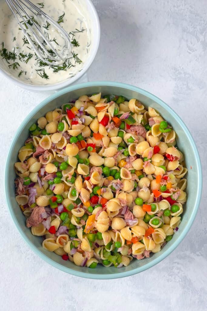 Overhead picture of whisked dressing and pasta salad.