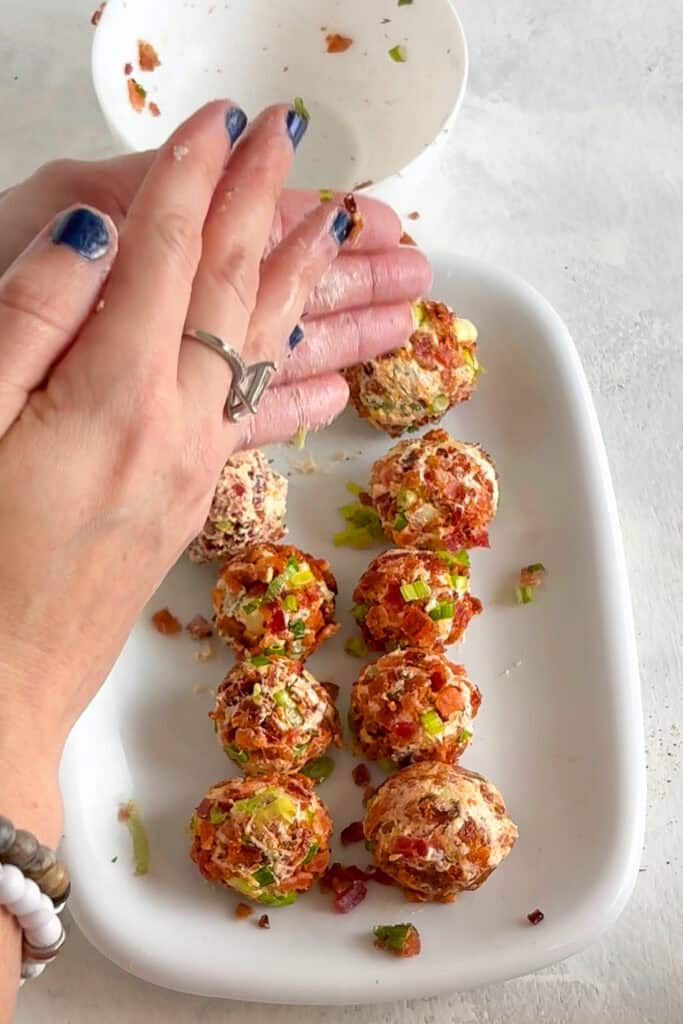 Overhead picture of me rolling the pickle balls into the bacon and green onion mixture.