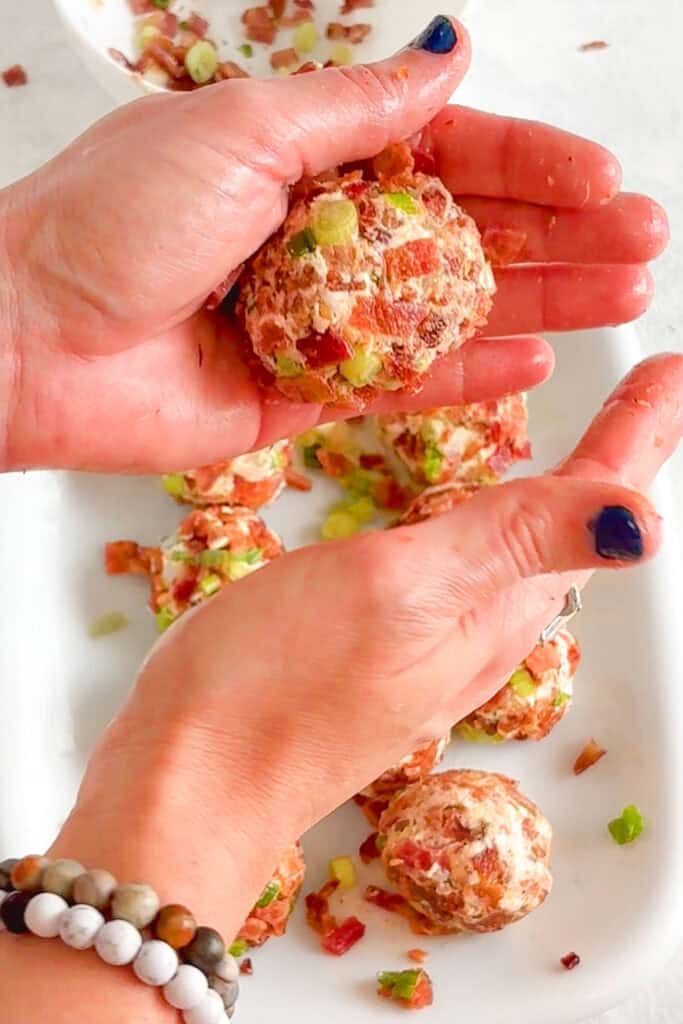 Overhead picture of me rolling the cream cheese pickles balls uniform in size.