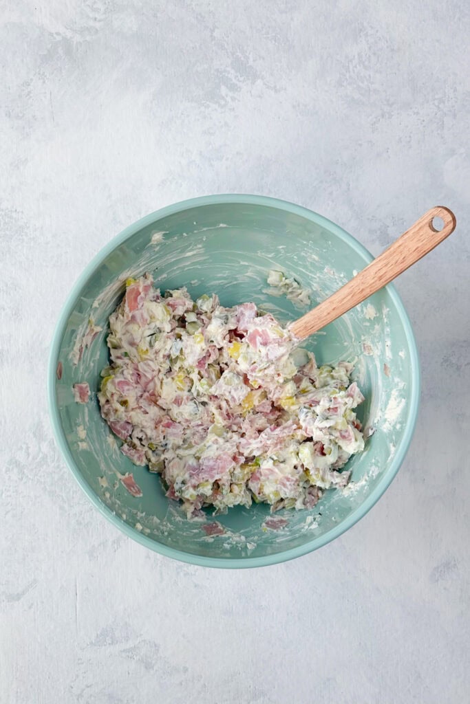 Overhead picture of pickle dip mix ready to be spread into a flour tortilla.